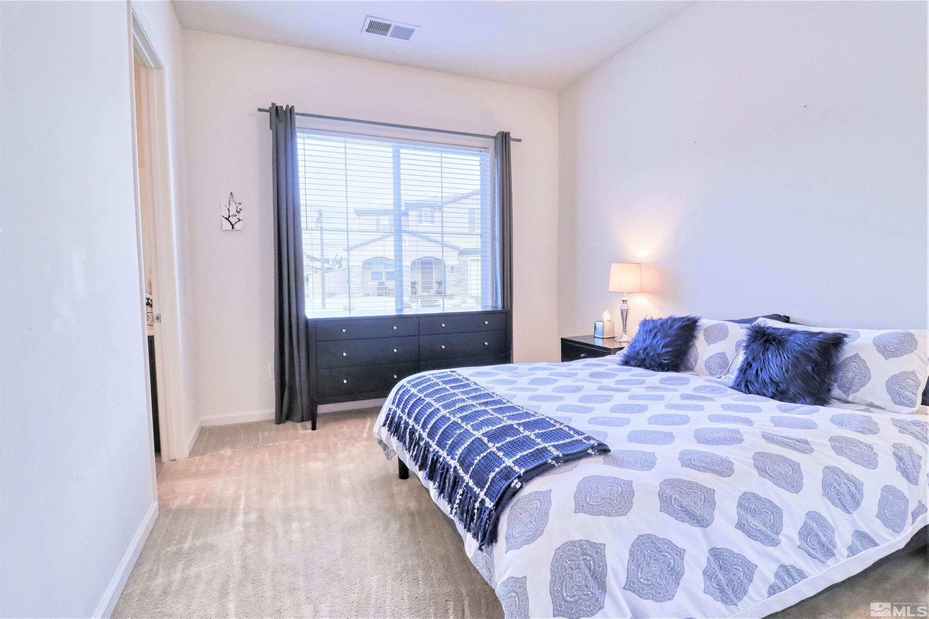 2790 Bonfire Lane Reno, NV 89521 - Photo 21 of 37 a bedroom with a large bed and a window
