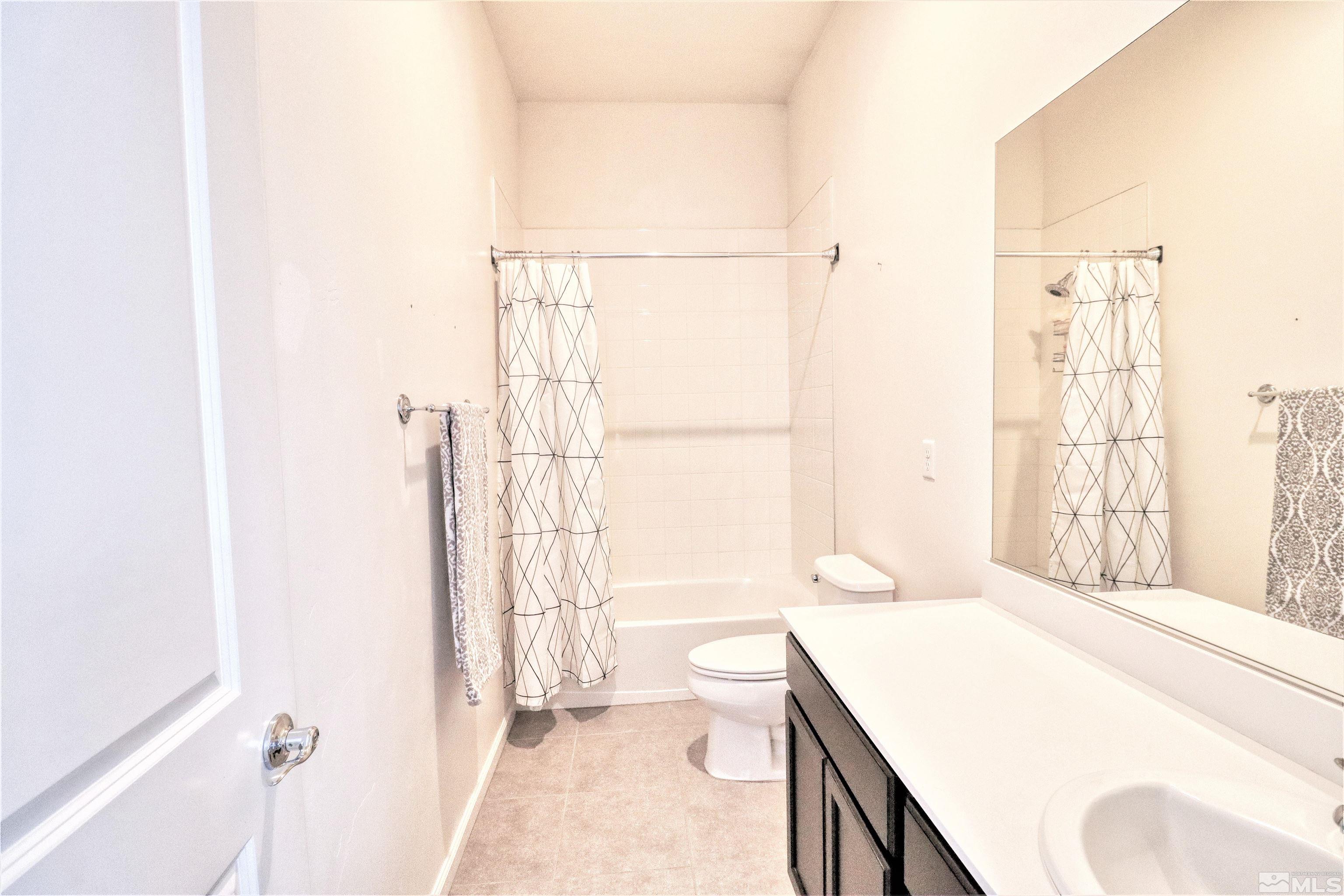 2790 Bonfire Lane Reno, NV 89521 - Photo 22 of 37 a bathroom with a granite countertop sink a toilet and shower
