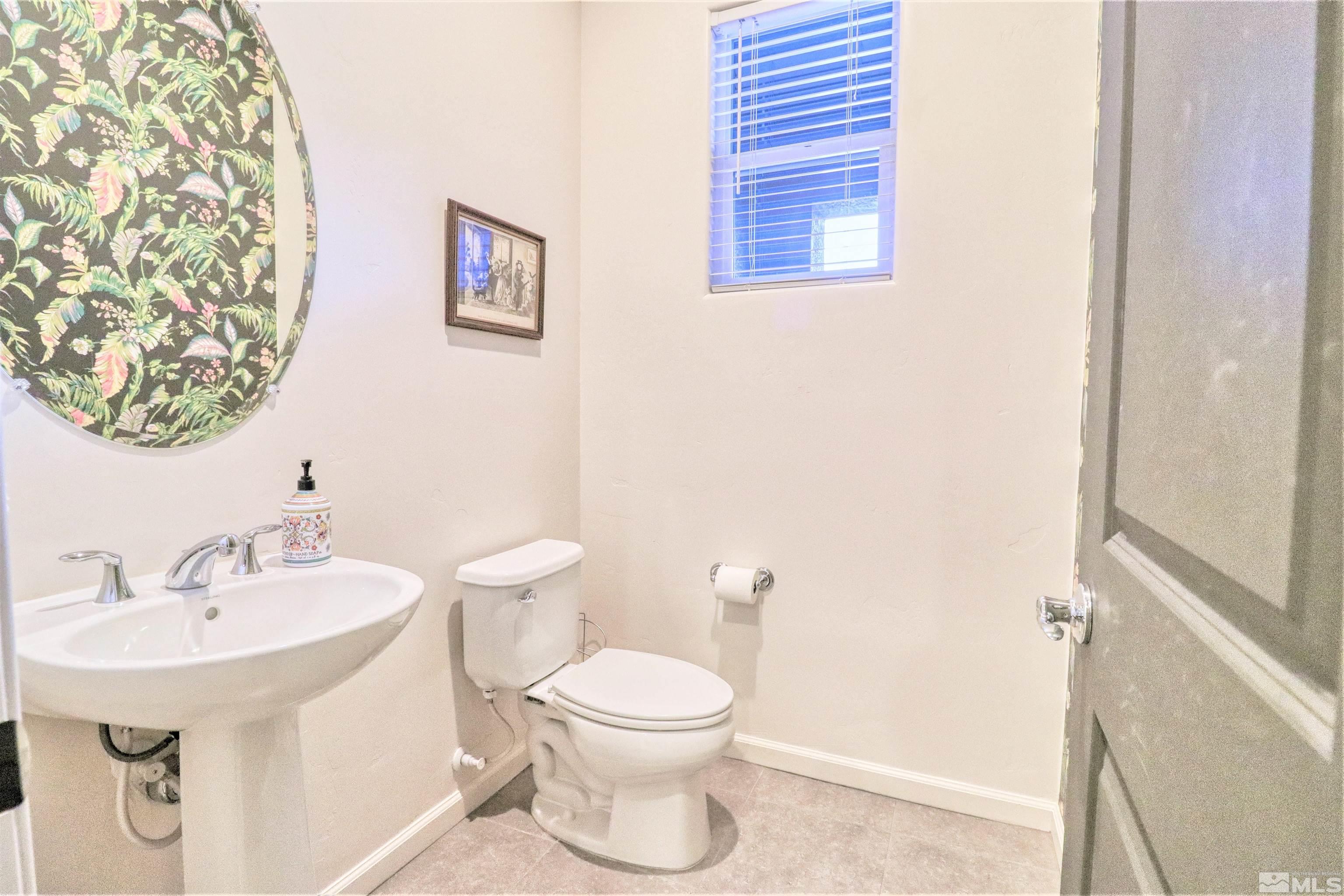 2790 Bonfire Lane Reno, NV 89521 - Photo 25 of 37 a bathroom with a toilet a sink and mirror