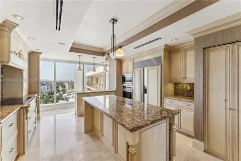 a kitchen with stainless steel appliances granite countertop a sink and refrigerator