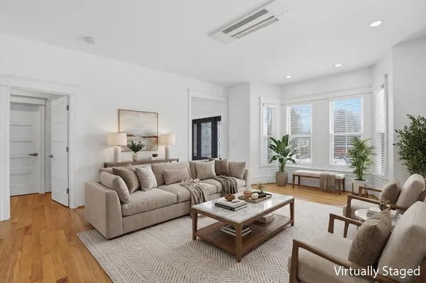 a living room with furniture rug and a table