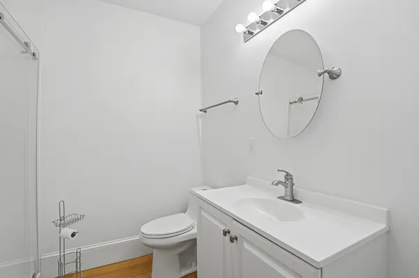 a bathroom with a sink a toilet and a mirror