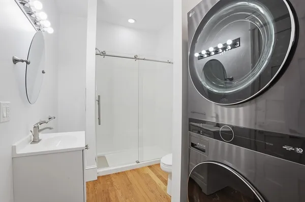 a bathroom with a sink a toilet and a mirror