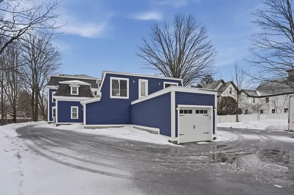 a front view of residential houses with yard and trees