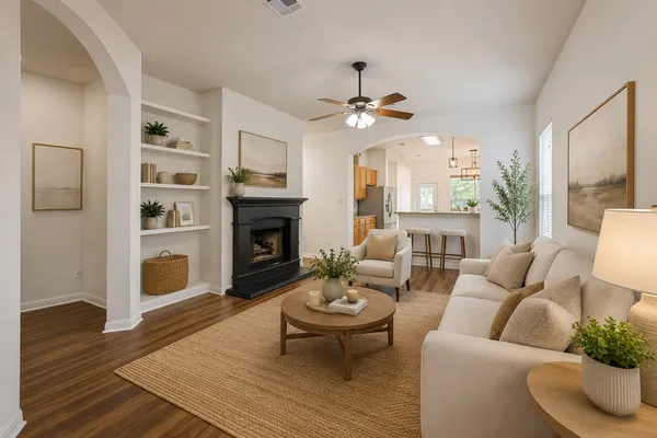an empty room with wooden floor fireplace and windows