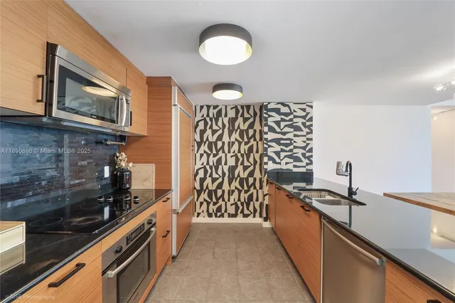 a kitchen with a sink stove and microwave