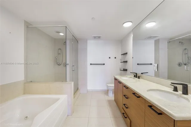 a bathroom with a granite countertop tub sink double vanity granite tub shower and mirror