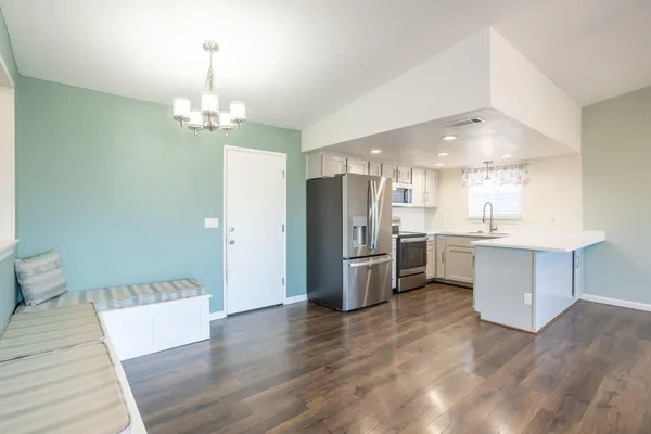 a view of kitchen with refrigerator microwave and stove