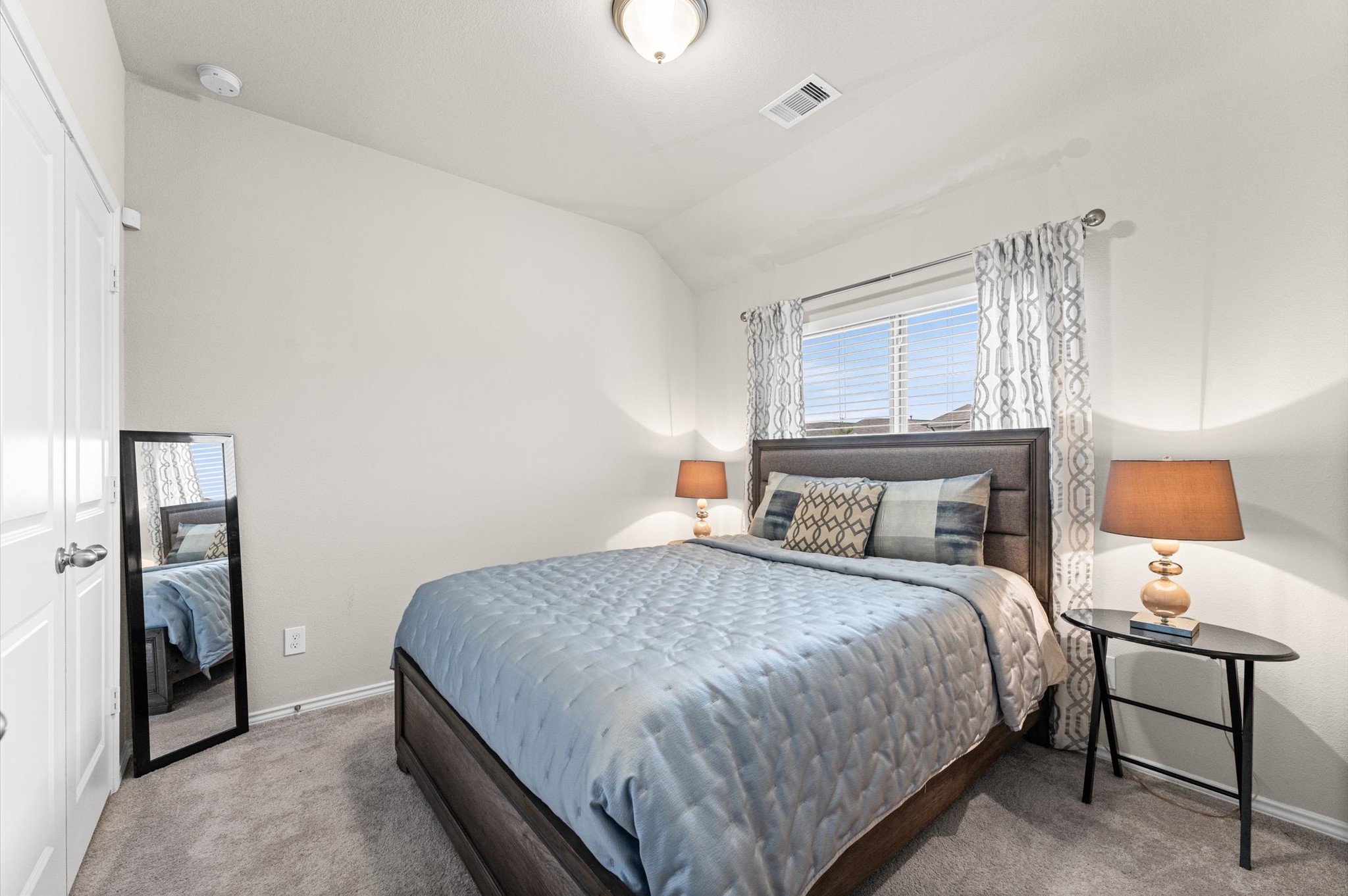 2702 Meadow View Lane Conroe, TX 77385 - Photo 8 of 26 a bedroom with a bed and a lamp