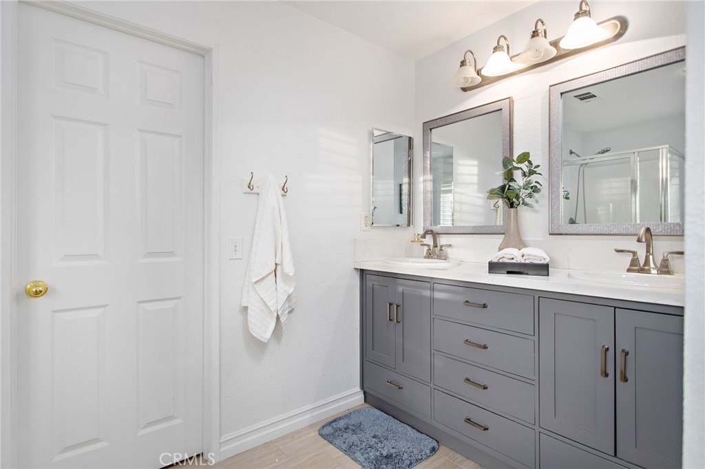 33686 Abbey Road Temecula, CA 92592 - Photo 22 of 37 a bathroom with a double vanity sink and mirror