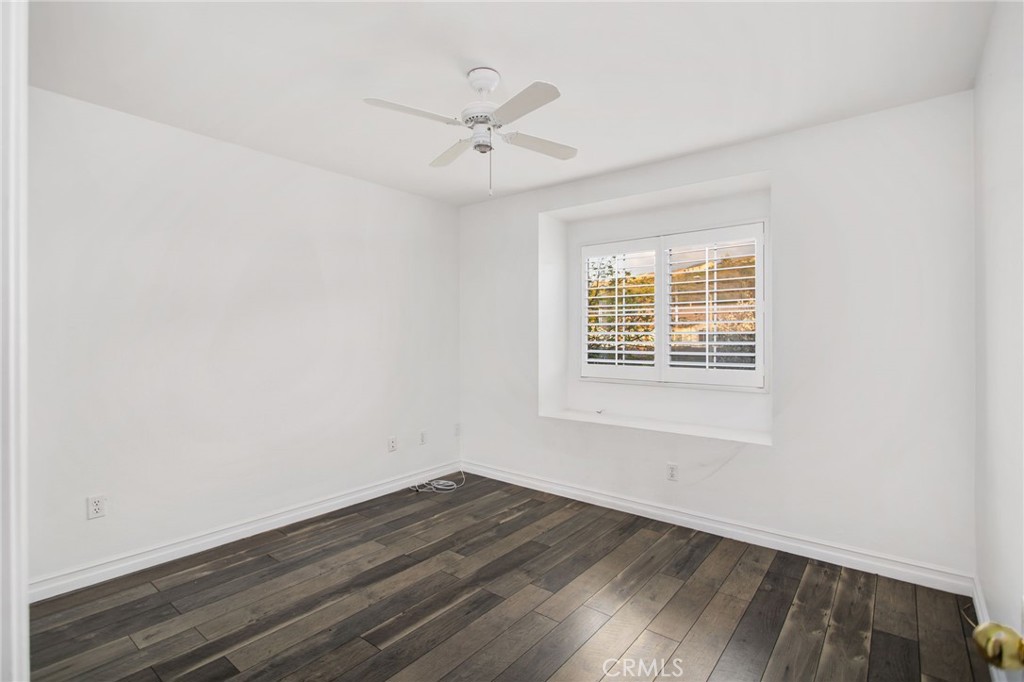 33686 Abbey Road Temecula, CA 92592 - Photo 26 of 37 an empty room with wooden floor fan and windows