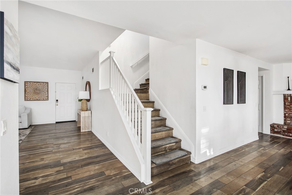 33686 Abbey Road Temecula, CA 92592 - Photo 5 of 37 a view of a hallway with wooden floor and staircase