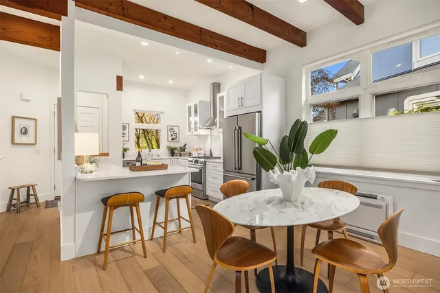 a dining room with furniture and wooden floor
