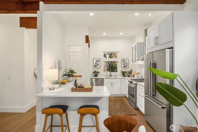 a kitchen with stainless steel appliances kitchen island granite countertop a sink and cabinets