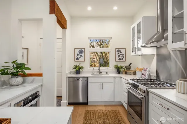 a kitchen with a sink stove and cabinets