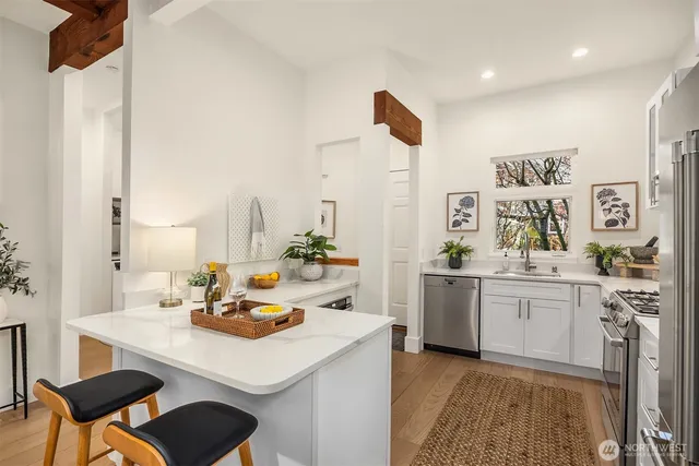 a kitchen with a sink cabinets and wooden floor