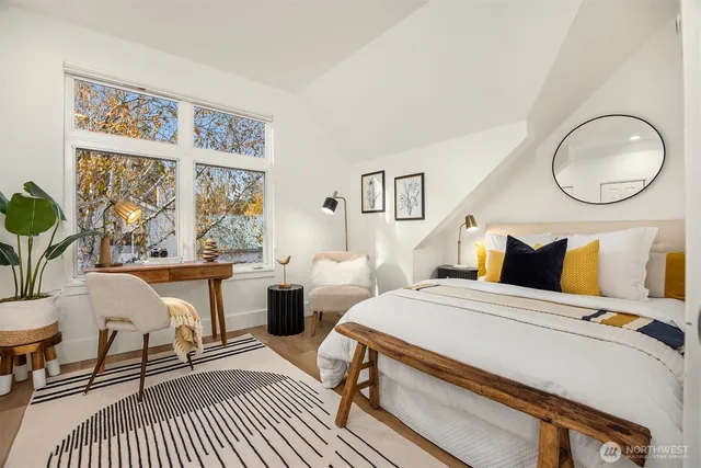 a bedroom with a bed a table and chair