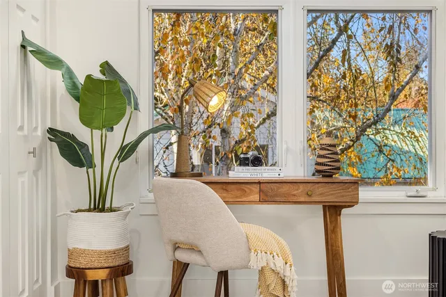 a view of a dining room with furniture and a window