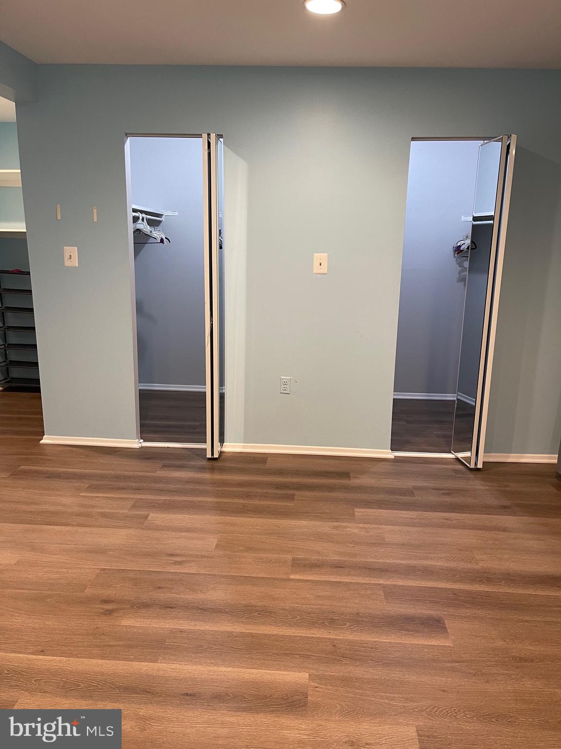 444 Girard Street, Unit 102 Gaithersburg, MD 20877 - Photo 15 of 30 an empty room with wooden floor and windows