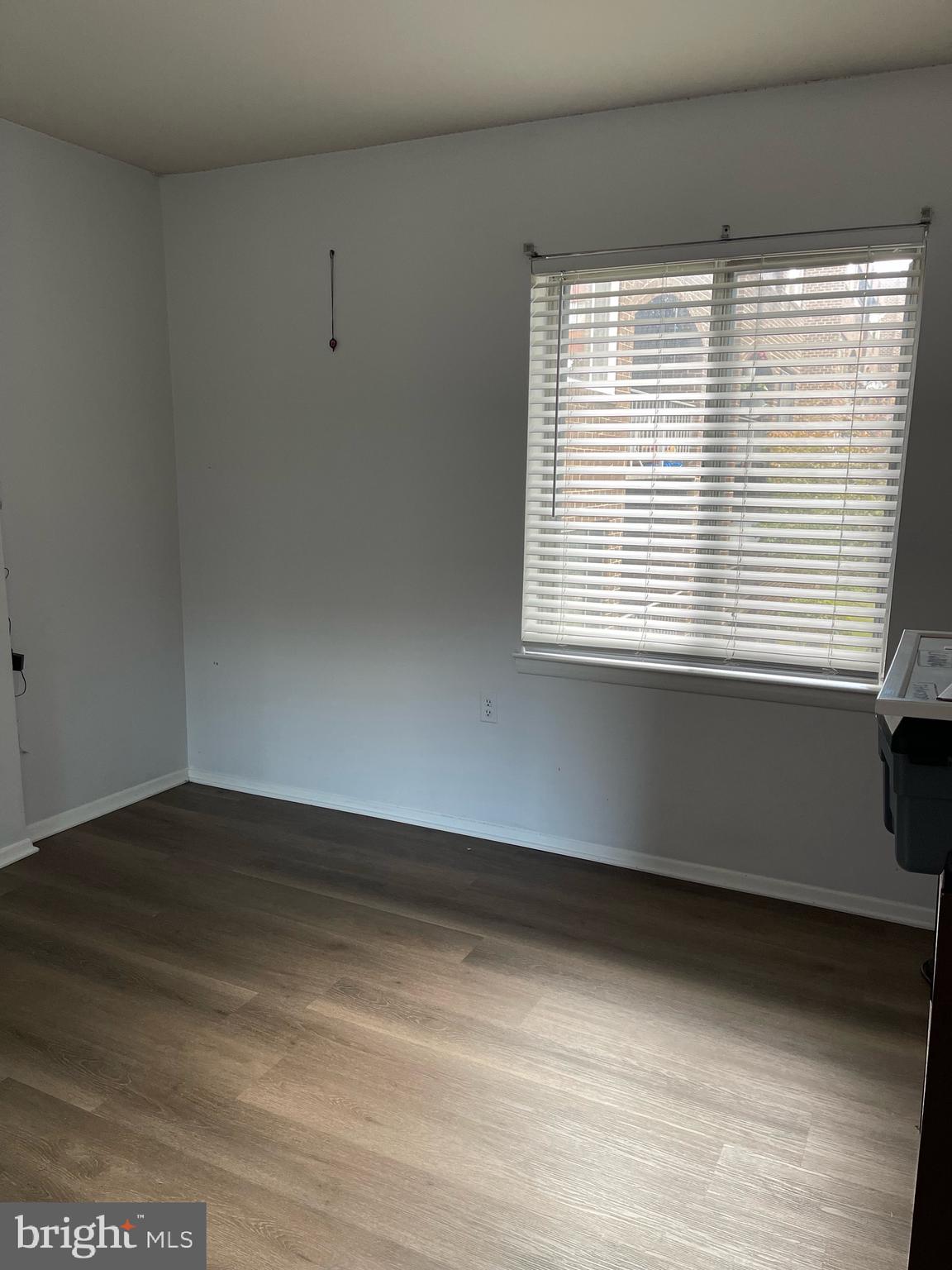 444 Girard Street, Unit 102 Gaithersburg, MD 20877 - Photo 20 of 30 a view of an empty room with wooden floor and a window