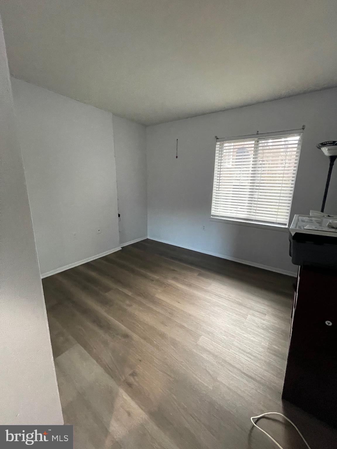 444 Girard Street, Unit 102 Gaithersburg, MD 20877 - Photo 21 of 30 an empty room with wooden floor and windows