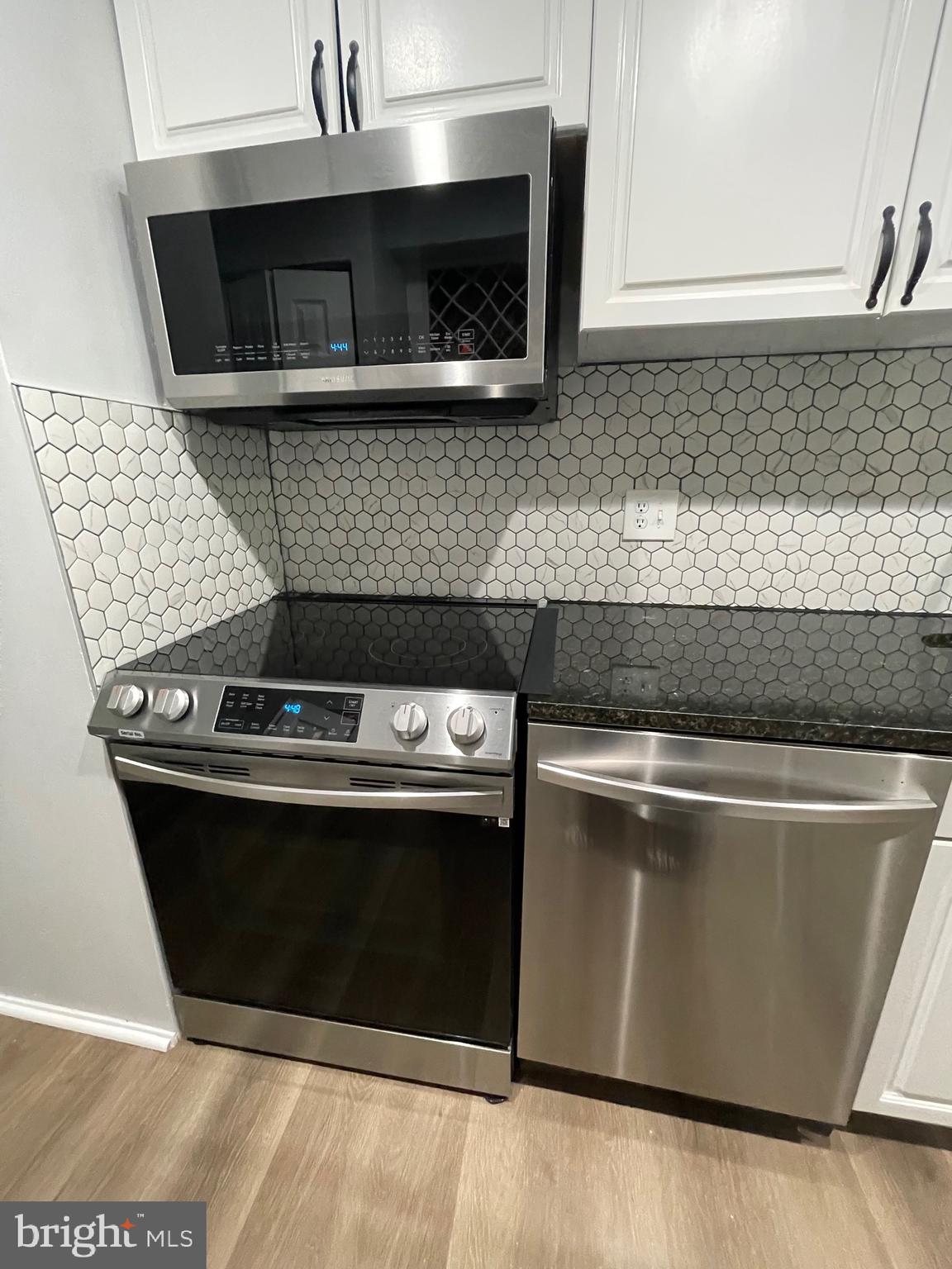 444 Girard Street, Unit 102 Gaithersburg, MD 20877 - Photo 26 of 30 a stove top oven sitting inside of a kitchen