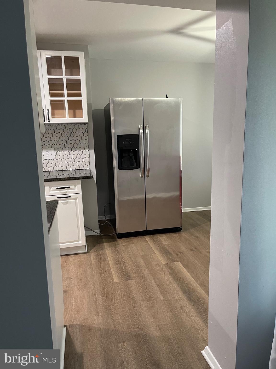 444 Girard Street, Unit 102 Gaithersburg, MD 20877 - Photo 28 of 30 a view of a refrigerator in kitchen and wooden floor