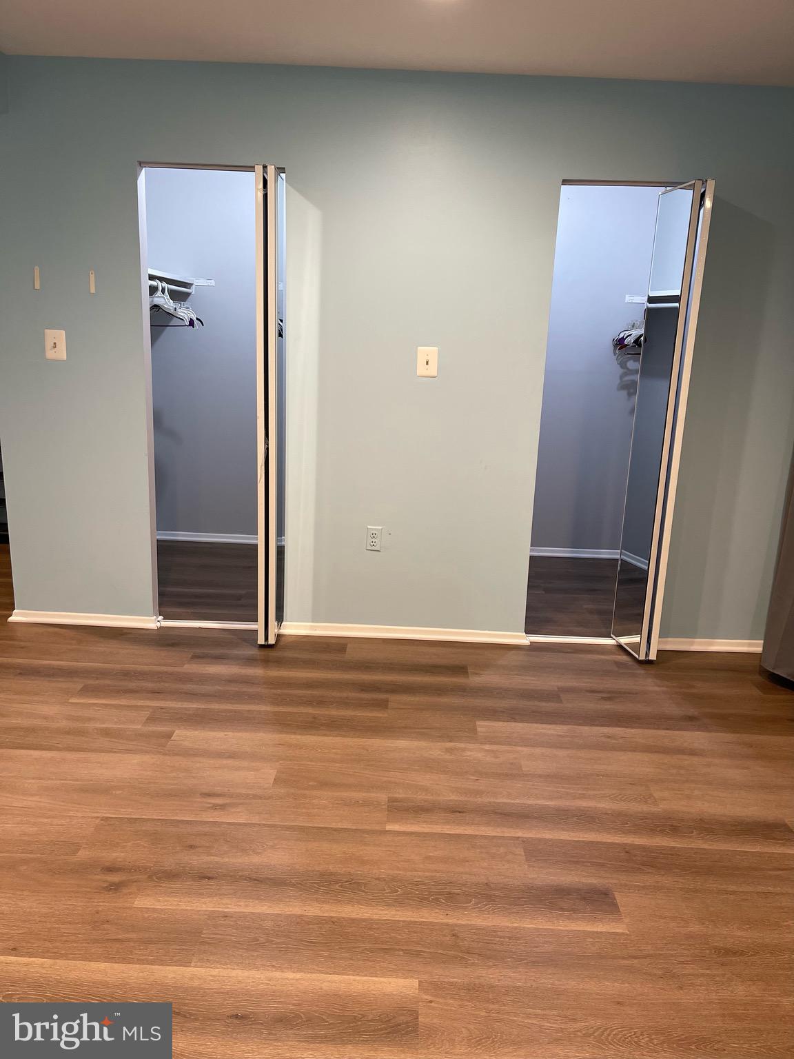 444 Girard Street, Unit 102 Gaithersburg, MD 20877 - Photo 3 of 30 an empty room with wooden floor and entrance