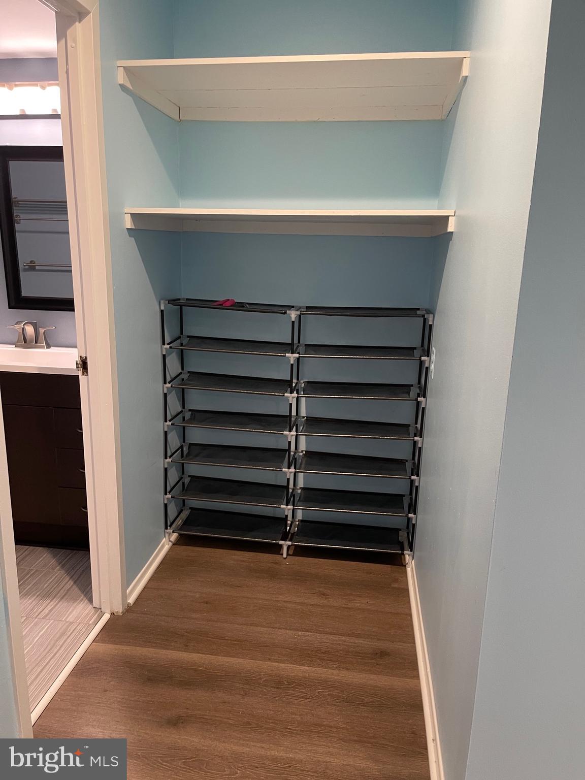444 Girard Street, Unit 102 Gaithersburg, MD 20877 - Photo 4 of 30 a view of walk in closet with empty racks