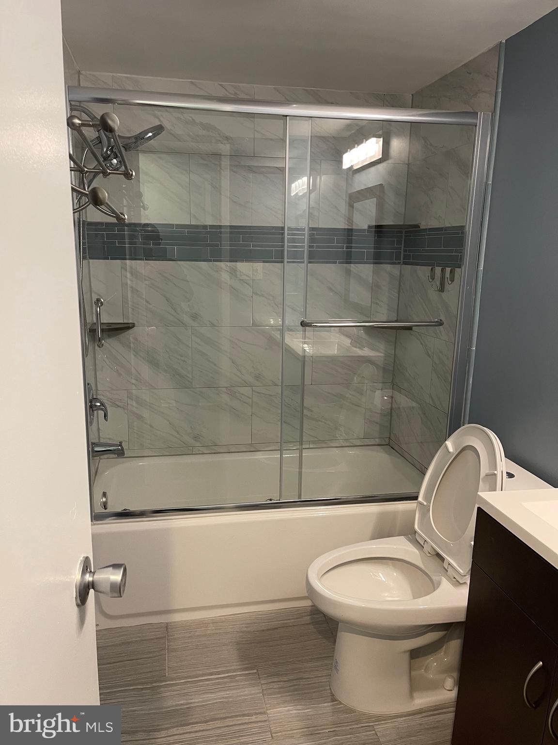 444 Girard Street, Unit 102 Gaithersburg, MD 20877 - Photo 5 of 30 a bathroom with a toilet and a shower