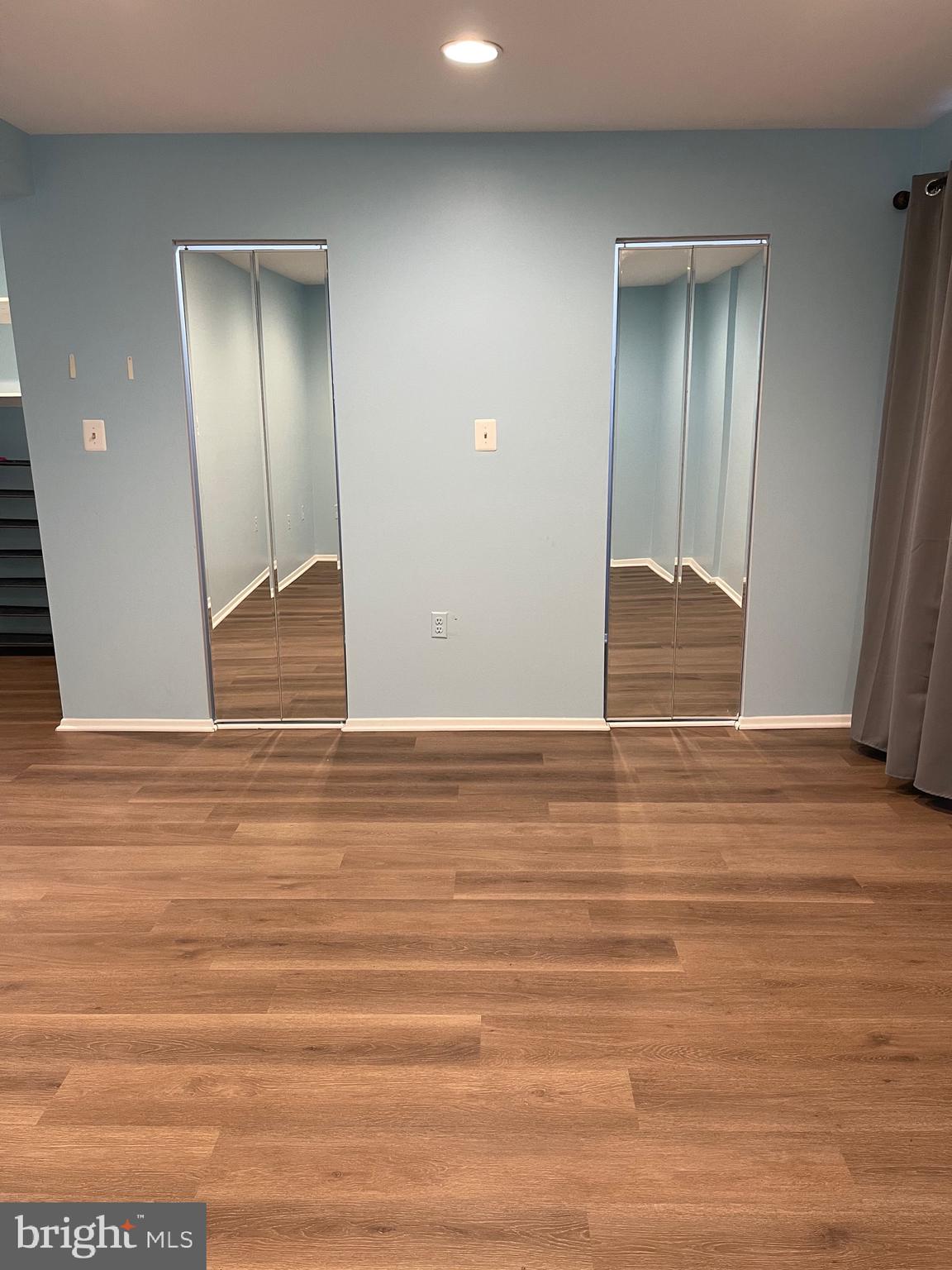 444 Girard Street, Unit 102 Gaithersburg, MD 20877 - Photo 6 of 30 an empty room with wooden floor and closet