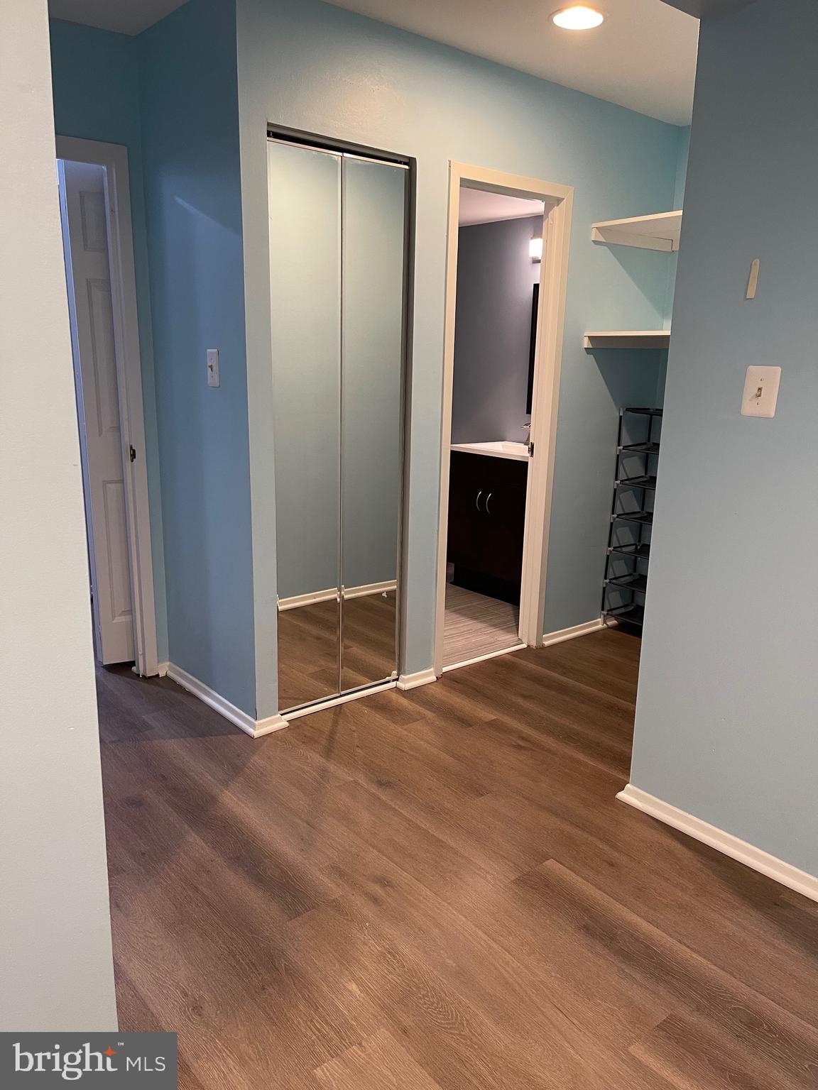 444 Girard Street, Unit 102 Gaithersburg, MD 20877 - Photo 9 of 30 a view of an empty room with closet and mirror