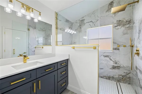 a bathroom with a sink mirror and a bath tub