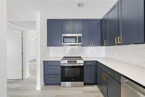 a kitchen with a stove and a microwave