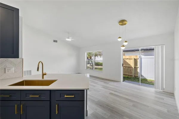 a kitchen with a sink cabinets and wooden floor