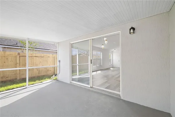an empty room with sliding glass door and glass door