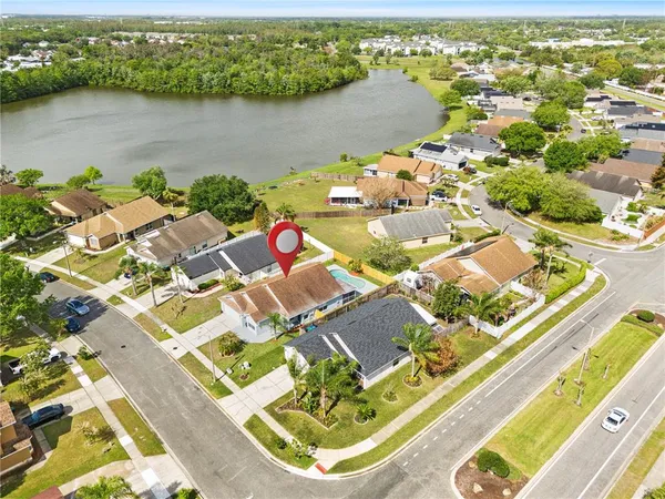 an aerial view of a house with a lake view