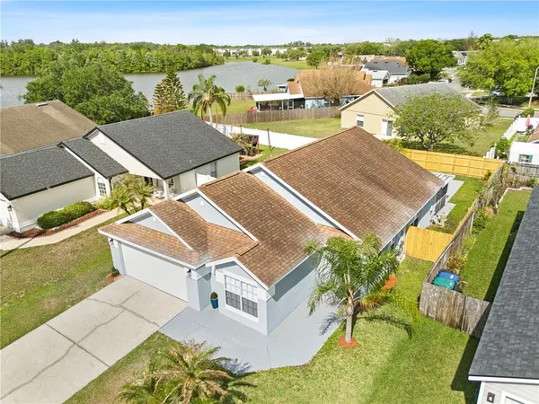 an aerial view of a house with a yard