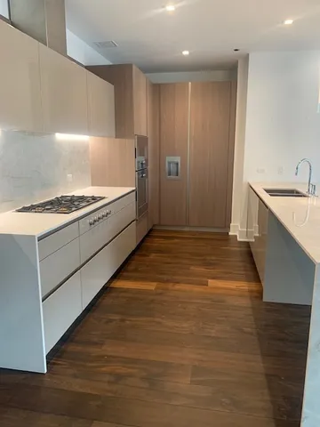 a kitchen with a sink and a stove top oven