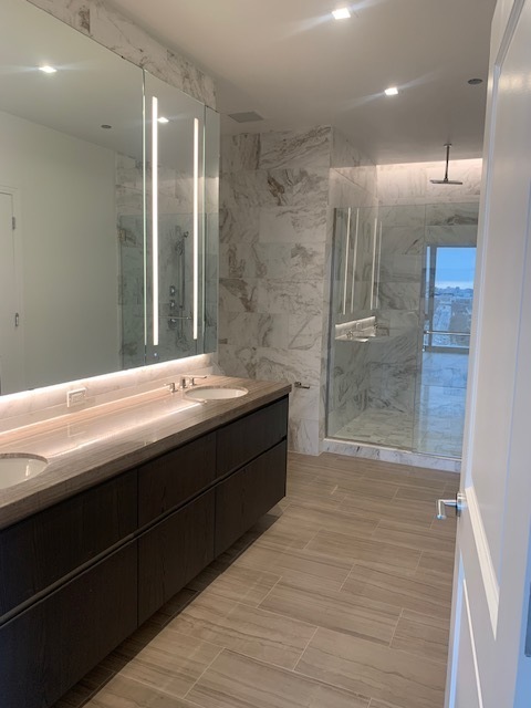 363 East Wacker Drive, Unit 1607 Chicago, IL 60601 - Photo 4 of 9 a bathroom with a double vanity sink a toilet and a shower