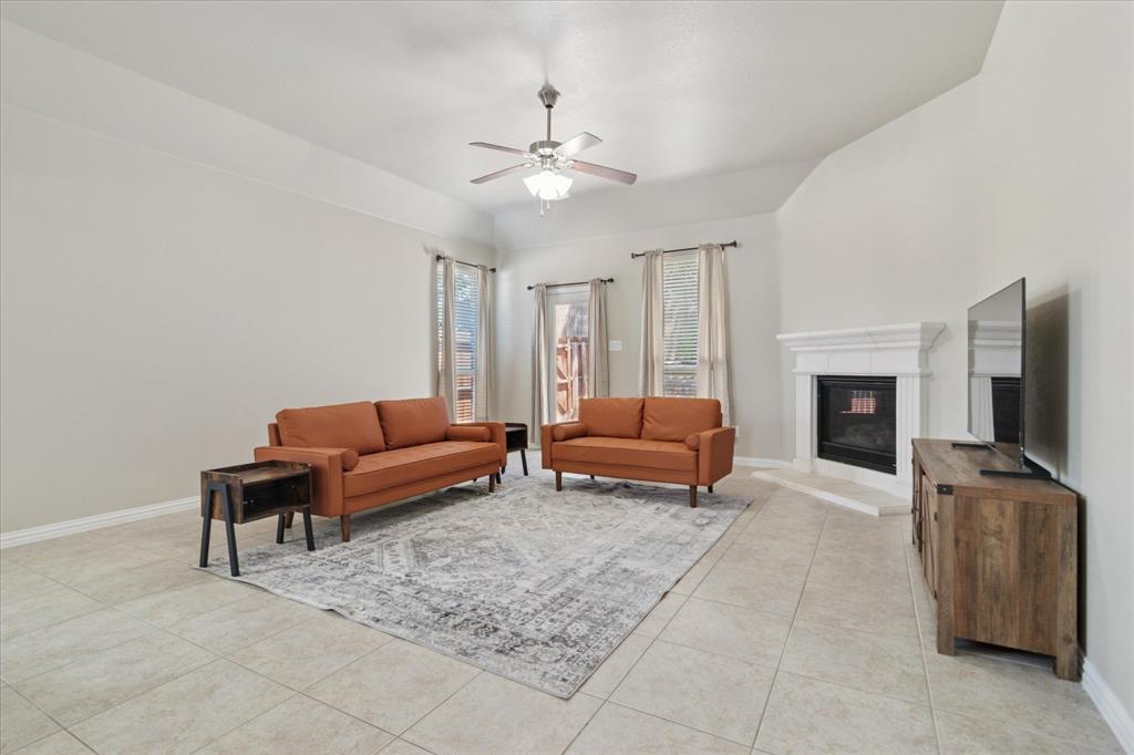 7401 Bishop Pine Road Denton, TX 76208 - Photo 11 of 25 a living room with furniture and a fireplace