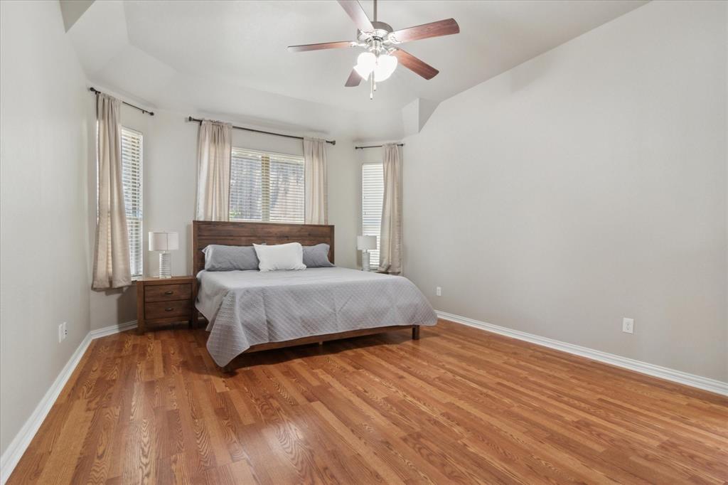 7401 Bishop Pine Road Denton, TX 76208 - Photo 13 of 25 a bedroom with a bed and wooden floor