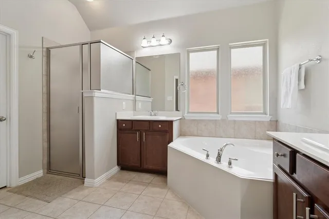 a bathroom with a bathtub and a shower