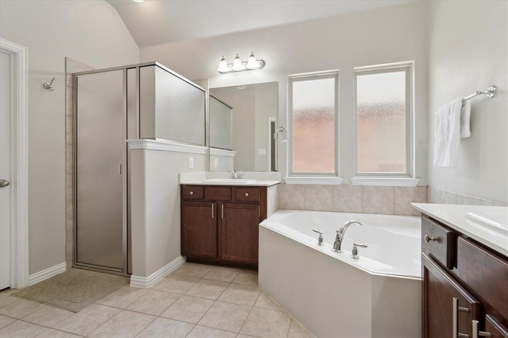 7401 Bishop Pine Road Denton, TX 76208 - Photo 15 of 25 a bathroom with a bathtub and a shower