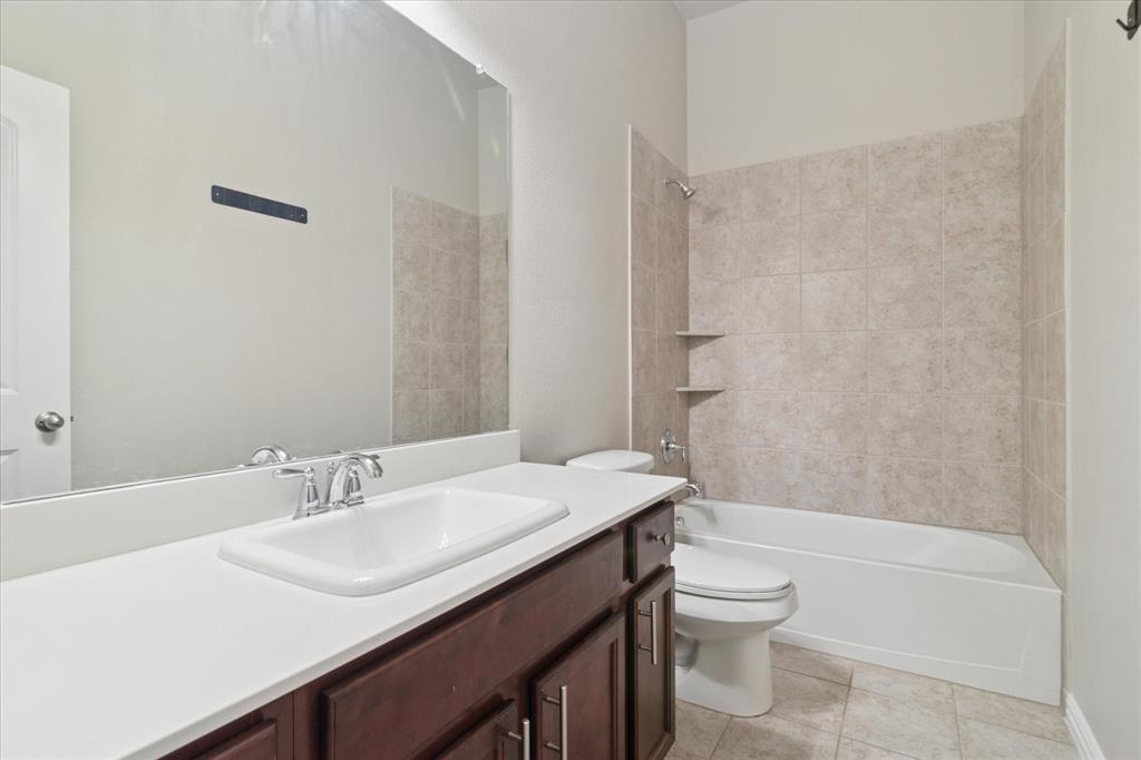 7401 Bishop Pine Road Denton, TX 76208 - Photo 17 of 25 a bathroom with a sink a toilet and shower