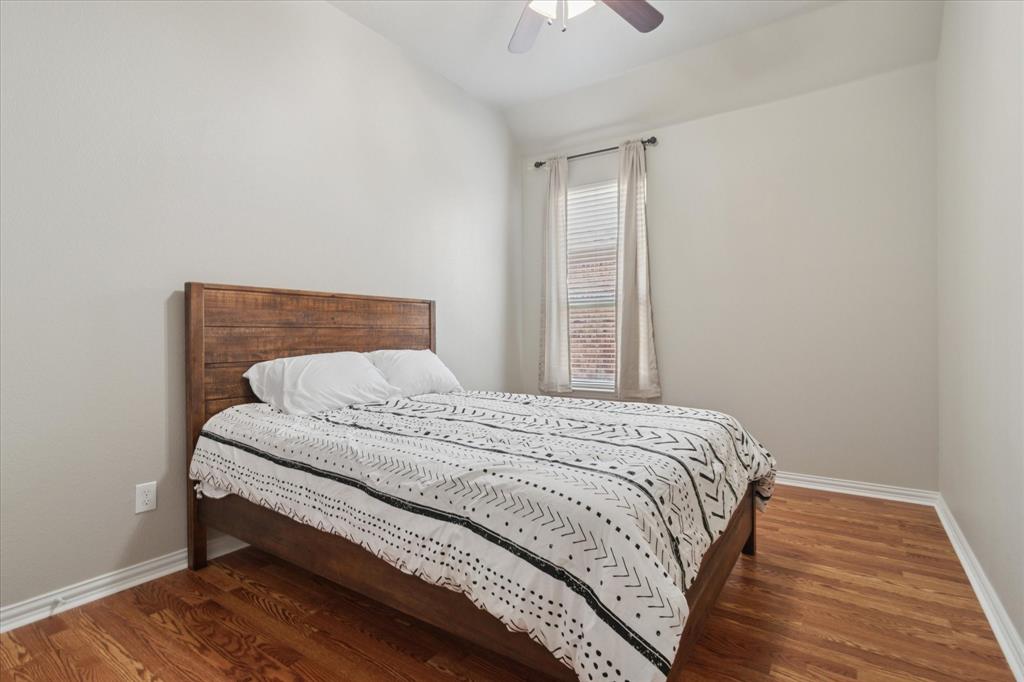 7401 Bishop Pine Road Denton, TX 76208 - Photo 19 of 25 a bedroom with a bed and wooden floor