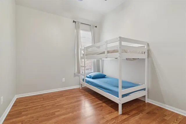 a view of a room with wooden floor and white walls