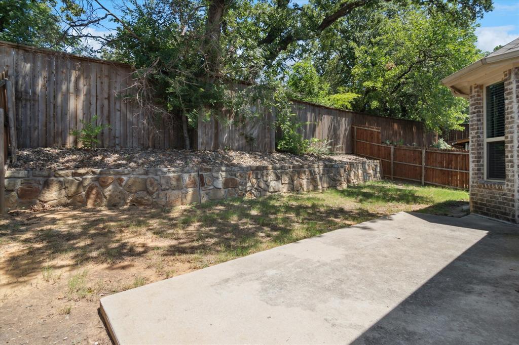 7401 Bishop Pine Road Denton, TX 76208 - Photo 23 of 25 a view of a backyard with wooden fence