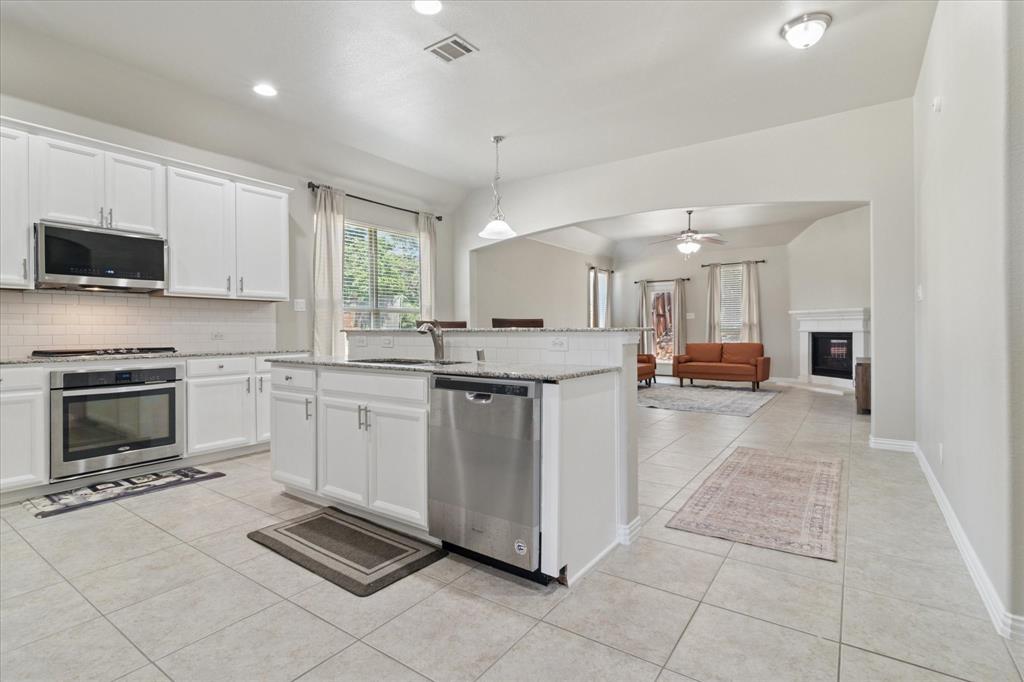 7401 Bishop Pine Road Denton, TX 76208 - Photo 8 of 25 a kitchen with cabinets and a stove top oven