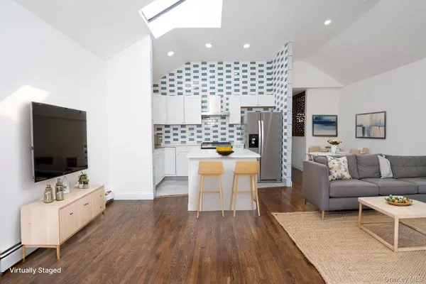 a living room with furniture wooden floor and a flat screen tv